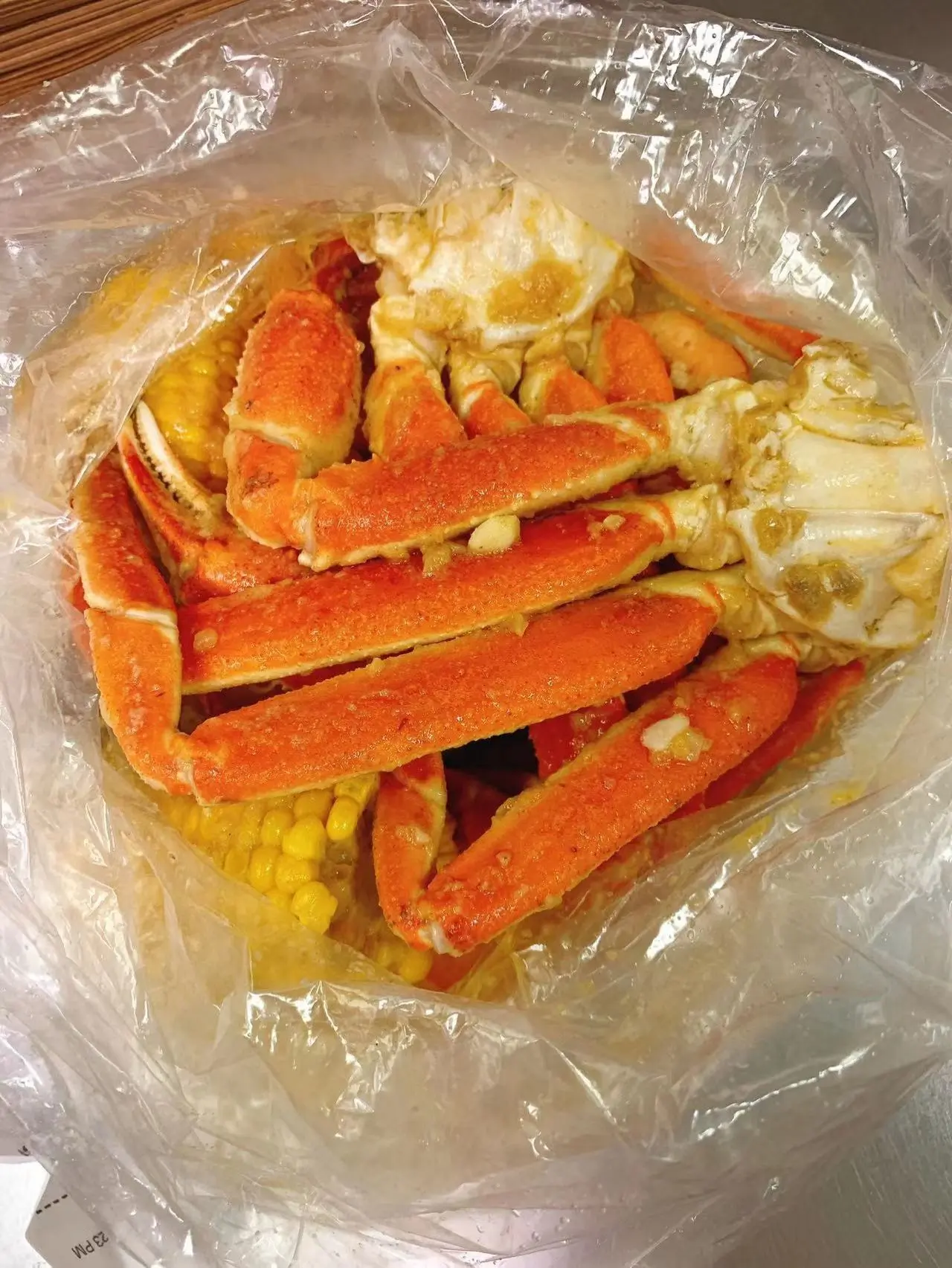 Garlic snow crab legs stored in plastic bag at Captain Crab, a Seafood Restaurant in Lufkin